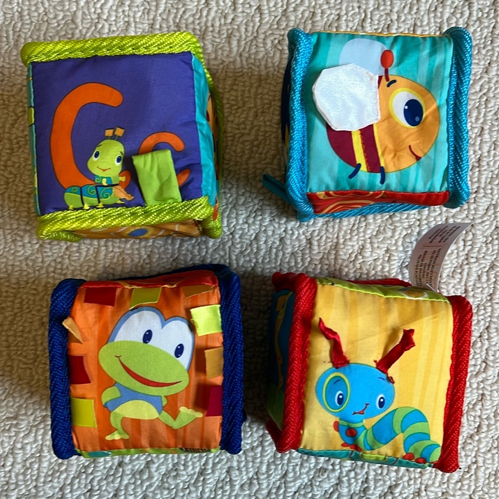 Bright Starts - Set of 4 soft material baby blocks.